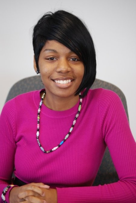 Portrait of professor Montgomery sitting in her office chair.